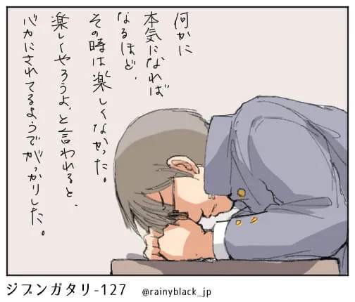机に頬をつけて悩む男子高校生